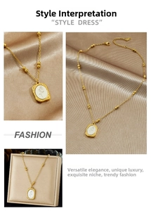 Detail of gold chain necklace with white oval rose pendant on champagne silk background