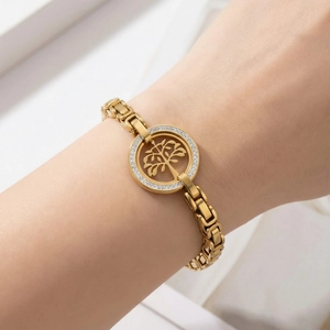 Gold stainless steel Tree of Life bracelet with pavé rhinestones on a woman's wrist
