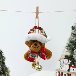 Close-up of plush Christmas bear ornament with festive hat, scarf and golden metal bells