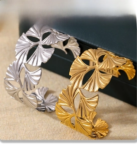 Detail of PVD electroplated ginkgo leaf cuff bracelets in gold and silver finish