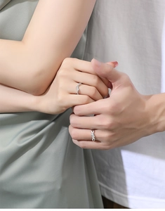 Close-up of S925 sterling silver couple rings with twisted rope and pavé setting designs