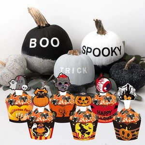 Close-up of Halloween cupcake wrappers and toppers with spooky designs and pumpkin decor