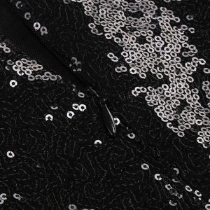 Detailed view of the invisible zipper on a black and silver sequined evening dress