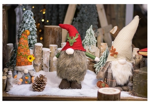 Detailed close-up of three festive Christmas and autumn gnomes with knit hats and artificial fur