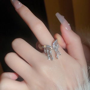 Detail of silver tassel ring with marquise-cut zircons on a hand with luxury style
