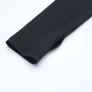 Detail of black elastic knitted sleeve featuring a functional thumb hole design for women