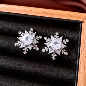 Exquisite silver snowflake stud earrings with sparkling cubic zirconia in a jewelry box