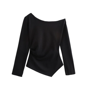 Detail of black long sleeve top with asymmetric off-shoulder neck and side ruched waist