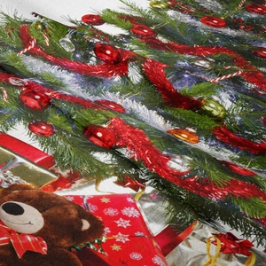 Close-up detail of Bohemian Christmas tapestry fabric showing teddy bear and festive tree prints