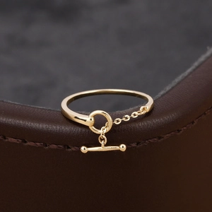 Minimalist gold S925 silver OT clasp chain ring on dark leather background