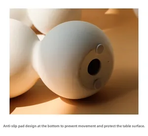Detail view of the anti-slip bottom pads on a minimalist matte white ceramic vase