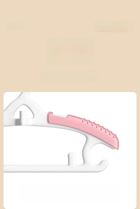 Detail of baby clothes hanger featuring rounded edges to prevent fabric snagging