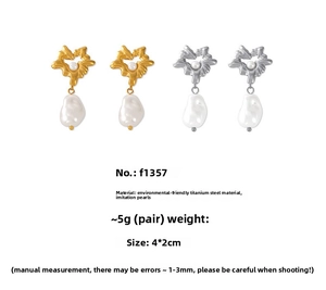 Detail shot of vintage heart pearl earrings in 18K gold and silver finish on white backdrop