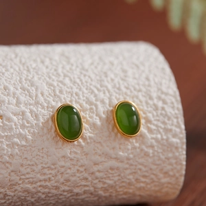 Macro shot of oval green jasper stud earrings set in gold plated 925 sterling silver