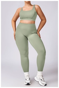 Detail of sage green high-waist yoga set featuring a sports bra and tight leggings