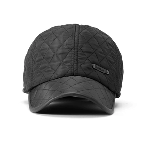 Close-up of diamond quilted black fabric and side metal brand logo on baseball cap