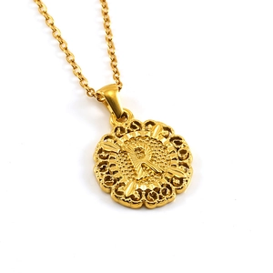 Detail of 18k gold plated round necklace pendant with letter R and hollow pattern