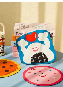 Three cute cartoon diatom mud coasters on blue table with aesthetic lifestyle setting