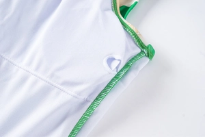 Detail view of swimsuit lining with green stitched edge and removable padding slot