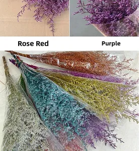 Close-up of colorful dried flower bouquets in rose red and purple transparent wraps