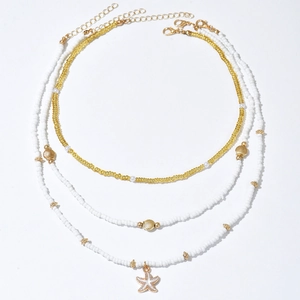 Three-piece beach necklace set with gold beads, starfish pendants and shell charms