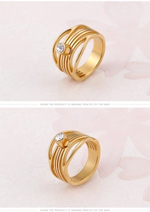 Detail view of gold hollow ribbed ring with a central round sparkling white gemstone