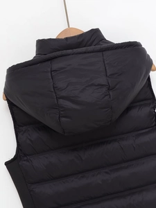 Vue détaillée de la texture matelassée et de la capuche intégrée de ce gilet noir rembourré