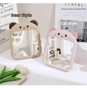 Detail of cute bear and cat shaped desktop makeup mirrors with scalloped wavy frames