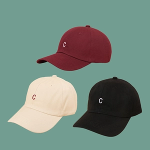 Close-up of embroidered C letter detail on cotton canvas baseball caps in multiple colors