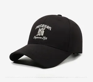 Detail of white narason embroidery and Improve Life text on a black cotton baseball cap