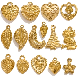 Assortment of vintage gold stainless steel charms including heart and leaf shapes