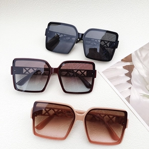 Close-up of three gradient oversized sunglasses with hollow mesh design temples
