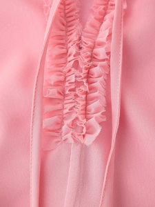 Detailed view of pink chiffon blouse featuring elegant V-neckline and ruffled layer decor