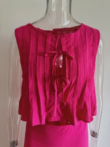 Magenta pleated cotton linen sleeveless crop top with center bow ties and ruffled hemline
