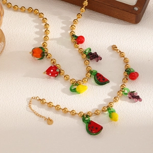 Colorful fruit pendant necklace in gold finish featuring watermelon and cherry charms