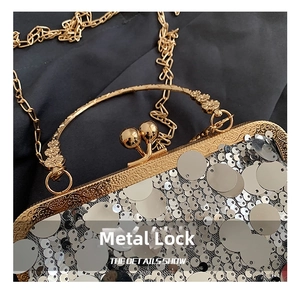 Detailed view of silver sequin evening bag featuring a vintage gold kiss-lock clasp