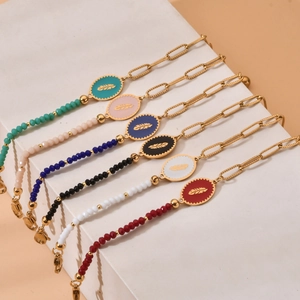 Set of six gold stainless steel bracelets with colorful enamel charms and beads