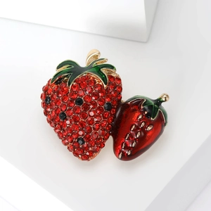 Minimalist red rhinestone strawberry brooch with green enamel leaves on golden base