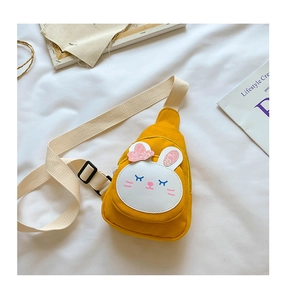 Close-up of yellow canvas chest bag featuring a cute white rabbit patch with pink glitter ears