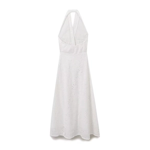White halter neck dress with hollow embroidery and open back on a flat lay background