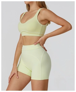 Detail view of lime yellow yoga bra with white contrast stitching and racerback design