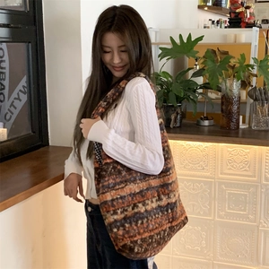 Cozy multi-color knit tote bag shown in a city cafe setting for a casual daily style