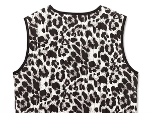 Detail of leopard print quilted vest showing clean seams and round neckline textures
