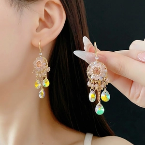 Bohemian style gold earrings with daisy motif, zircon teardrops and iridescent tassels