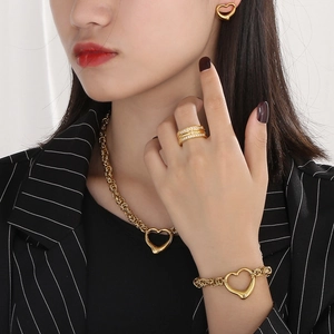 Golden heart-shaped stainless steel jewelry set featuring necklace earrings and bracelet