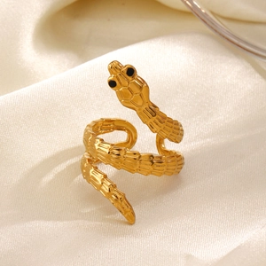 Vintage golden snake-shaped open ring with detailed scales and black eye accents on silk