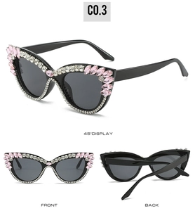 Detail view of rhinestone cat eye sunglasses with pink crystals and crystal accents
