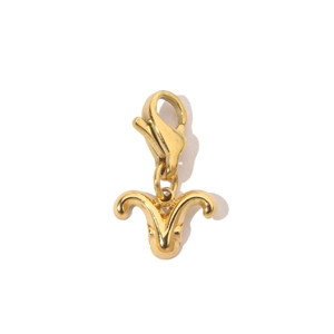 Macro shot of a 14K gold-plated Aries zodiac charm with a functional lobster clasp
