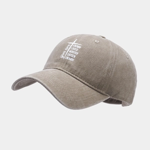 Close-up of vintage washed khaki baseball cap with religious cross and letter embroidery