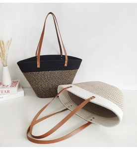 Detail of color-block woven tote bag showing cotton rope texture and faux leather handles